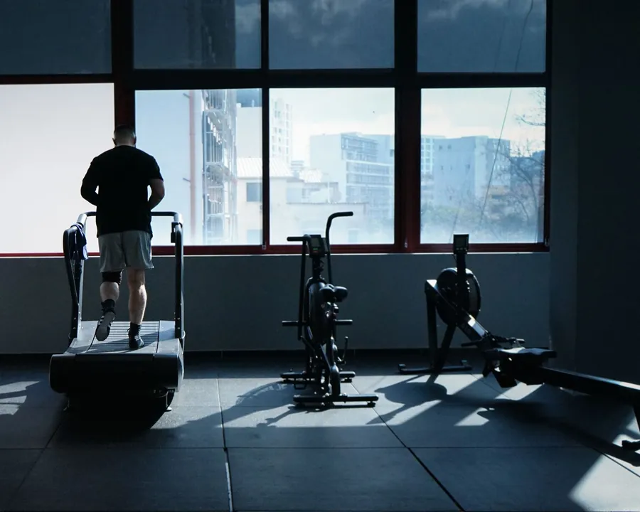 A person running on a treadmill in a gym