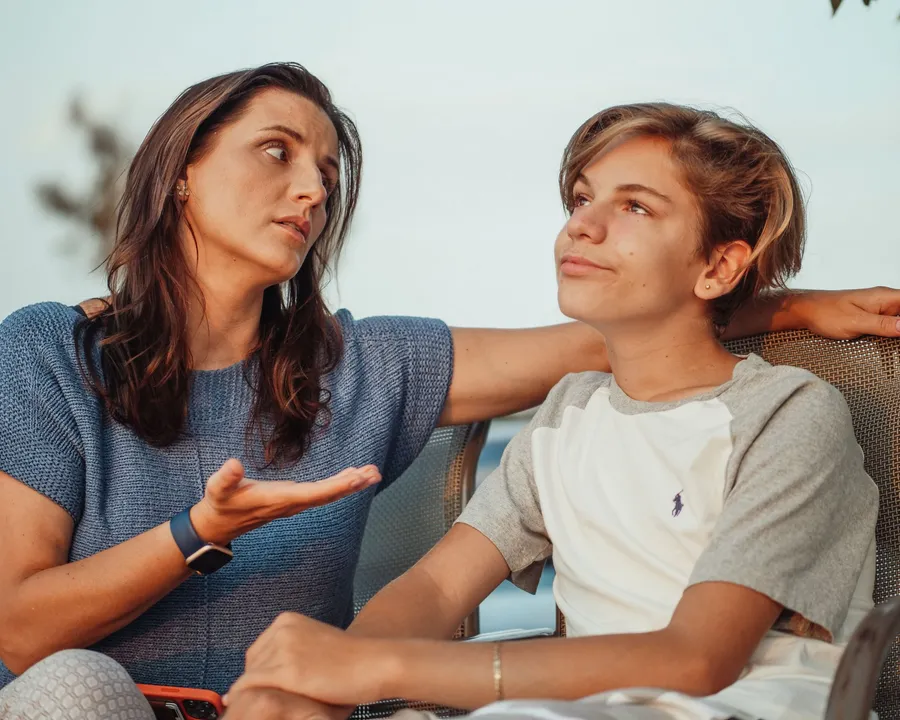 A parent and teenager talking together